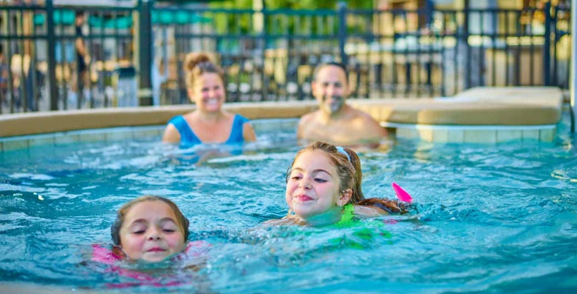 Kids and family having fun in pool