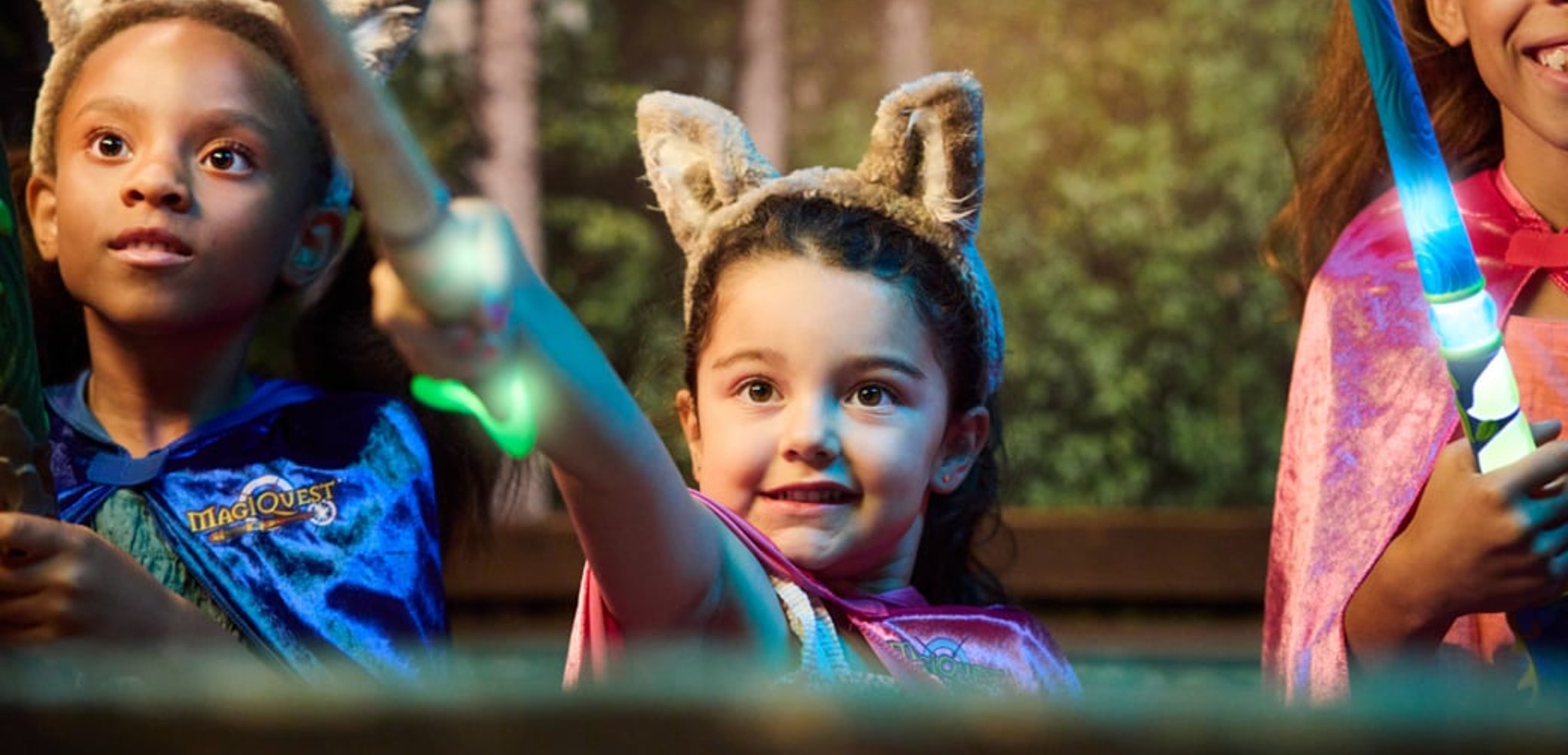 little girl placing a cape on little girl at MagiQuest