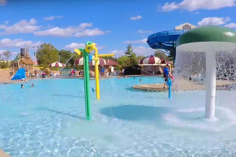 Kids play behind the outdoor water features 